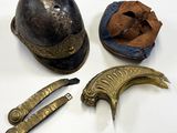 a helmet, knife, and other items that are on a table