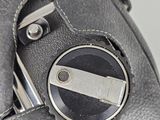 a close up of a cell phone with a button on it