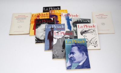 several books are arranged on a white surface with a white background