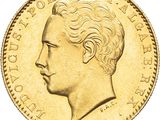 a close up of a gold coin with a man ' s face on it