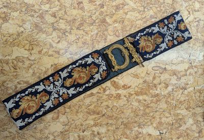 a belt that has a gold buckle on it