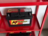 a red shelf that has two batteries on top of it