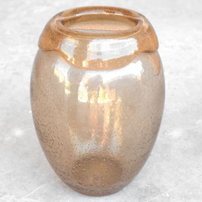 a glass vase that is sitting on a table