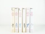 three books sitting on top of each other on a white surface