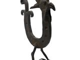 a metal sculpture of a bird with a crown on it ' s head