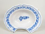 a blue and white plate with a flower design on it