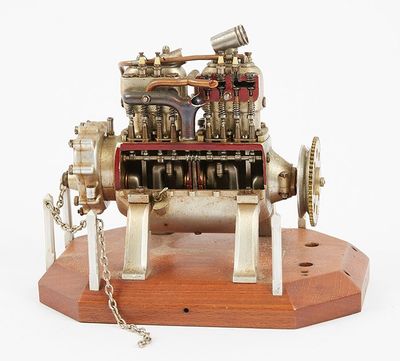 a small model of a steam engine on a wooden stand