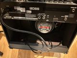 a guitar amplifier sitting on top of a wooden table