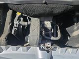 a picture of a car ' s engine in the back of the truck