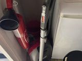 a vacuum that is sitting in the corner of a room