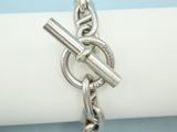 silver plated bracelet with a chain and a clasp on a napkin