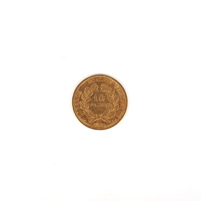 a close up of a gold coin on a white surface