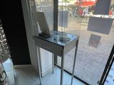 a glass display case with a laptop on top of it