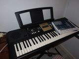 a keyboard that is sitting on a desk next to a chair