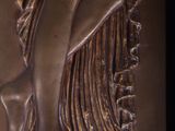 bronze sculpture of a woman holding a flower in her hand