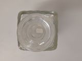 a glass block with a hole in it on a white surface