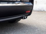 a close up of a black car parked on the street