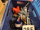 a blue bin filled with assorted tools in a store