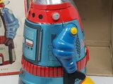 a toy robot that is sitting next to a box