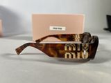 a pair of sunglasses sitting on a table next to a pink box