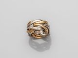 a close up of a gold and silver ring on a white surface