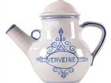 a white teapot with a blue and white design on it