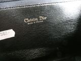 a close up of a black purse with a label on it