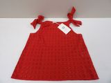 a red dress with a bow on the back and a tag on it