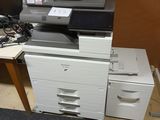 a pile of office supplies on a desk in a room