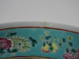 a close up of a bowl with flowers painted on it