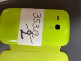 a cell phone with a sticker on it sitting on a table