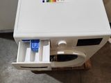 a small white oven with a drawer in the middle of it
