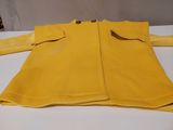 yellow coat on a white table with buttons on the sleeves