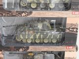 three toy tanks are in a package on a white surface