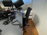 a desk with a computer and a monitor on it