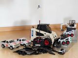 a toy truck and a truck with a crane on the back of it