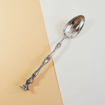 a spoon that is sitting on top of a yellow and white table