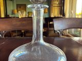 a glass decanter sitting on a table in a room