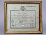 a gold frame with a certificate on it sitting on a table