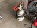 a red fire hydrant sitting next to a silver fire hydrant in a garage