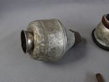 a small metal object on a table next to a smaller metal object
