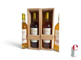 three bottles of wine in a wooden box with a white background
