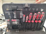someone is holding a tool case with a bunch of tools in it
