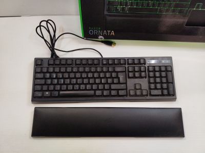 a computer keyboard and mouse on a desk next to a monitor