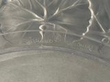 a close up of a glass plate with a flower on it