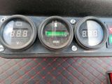 three gauges on the dashboard of a car