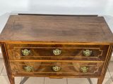 an antique wooden chest of drawers with brass pulls and drawers