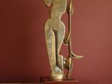 a statue of a woman holding a cat on a table