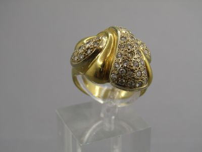 a close up of a gold and diamond ring on a clear surface