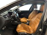 the interior of a car with two leather seats and a steering wheel